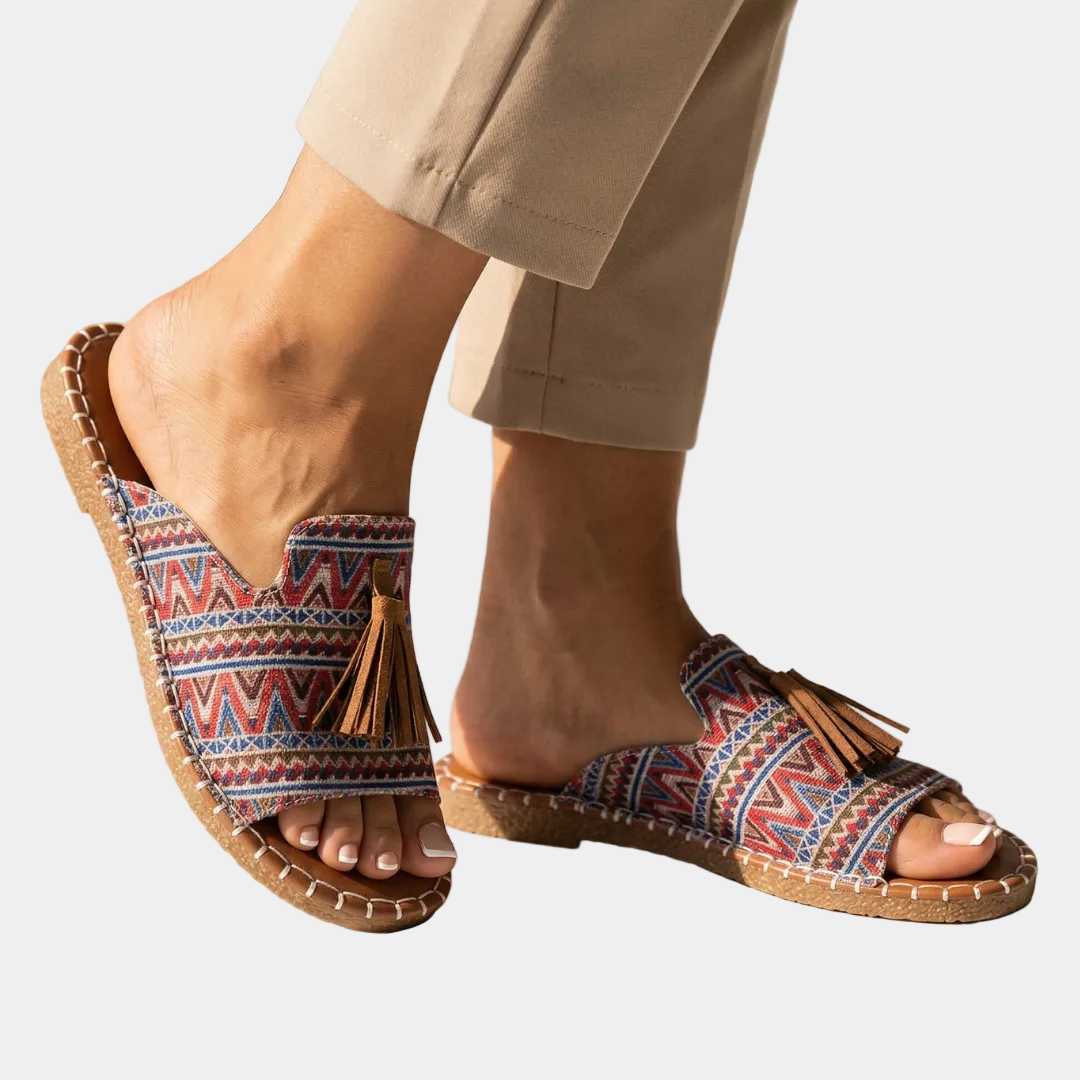 Platform slide sandals with multicolor zigzag fabric straps and tan cork sole, tassel detail