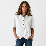 White asymmetric button-up blouse with short sleeves, point collar, curved hem detail
