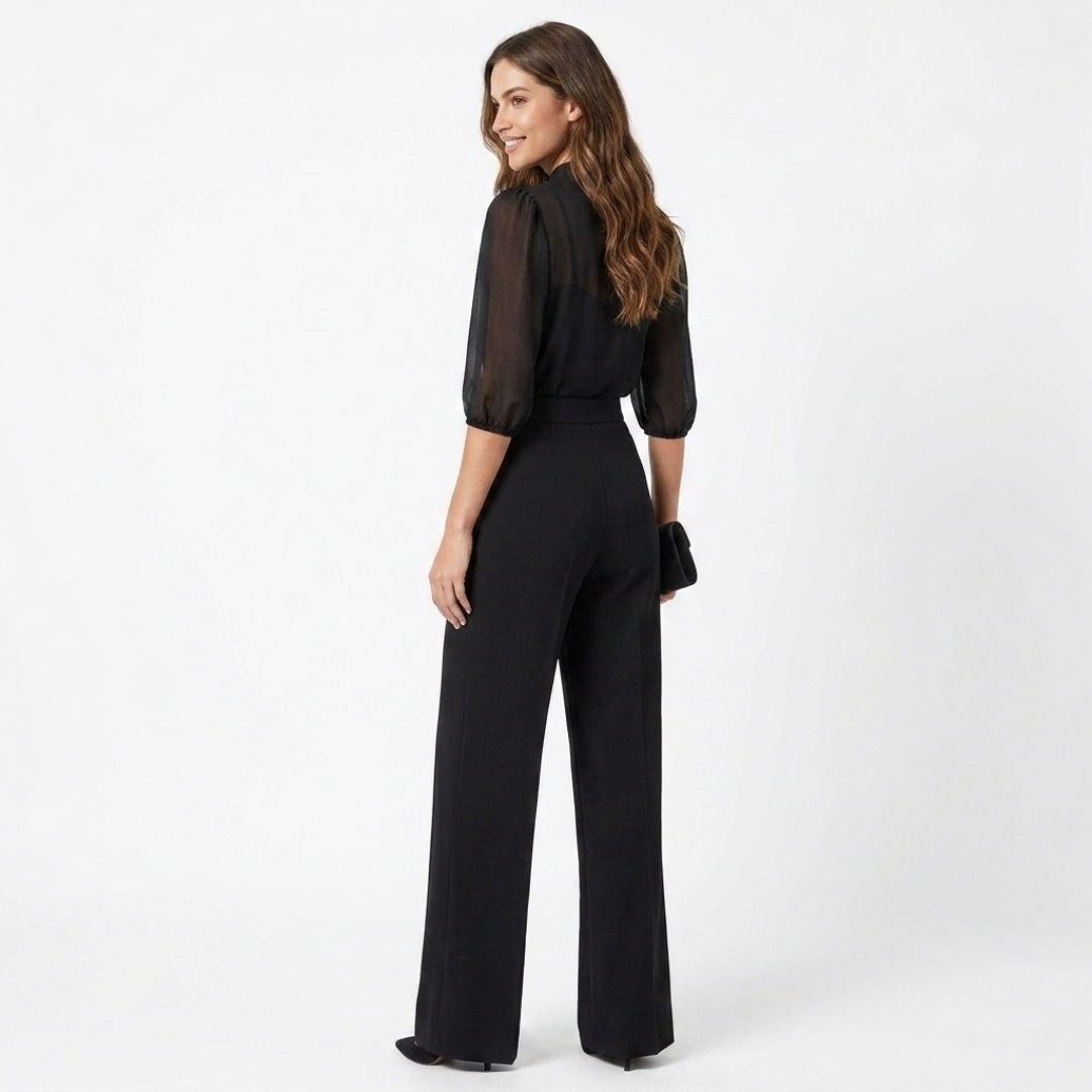 Black sheer blouse and high-waist wide-leg pants with belt, side view