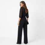 Black sheer blouse and high-waist wide-leg pants with belt, side view