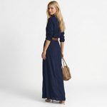Long navy maxi dress with V-neck, rolled sleeves, and brown waist belt