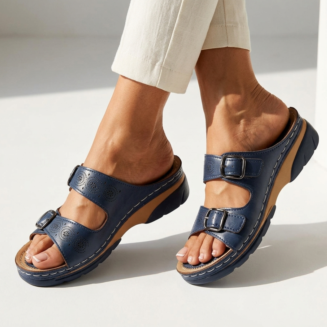 Navy orthopedic sandals with two buckles, perforated straps, and supportive tread sole
