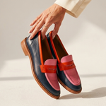 Pair of color-block leather loafers with pink-and-orange straps and dark navy sides