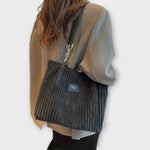 Charcoal ribbed shoulder bag with chain strap, worn on model
