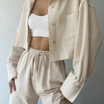 Light beige two-piece pants set with collared button-up top and drawstring trousers
