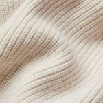 Cream textured knit cardigan fabric close-up with ribbed pattern