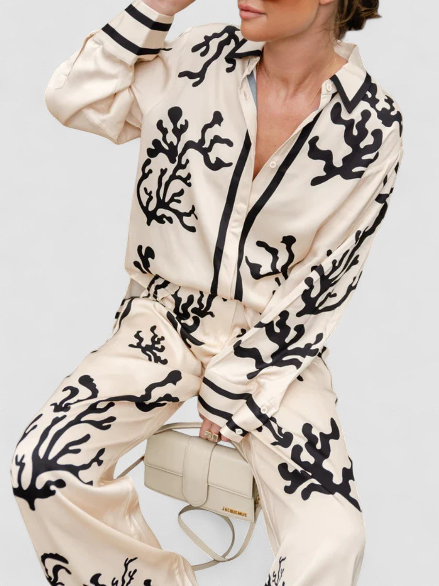 Silk pajama set in cream and black coral print, button-front long-sleeve top and pants