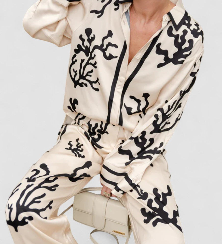 Silk pajama set in cream and black coral print, button-front long-sleeve top and pants