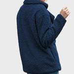 Navy sherpa puffer jacket back view with thick textured fabric and long sleeves