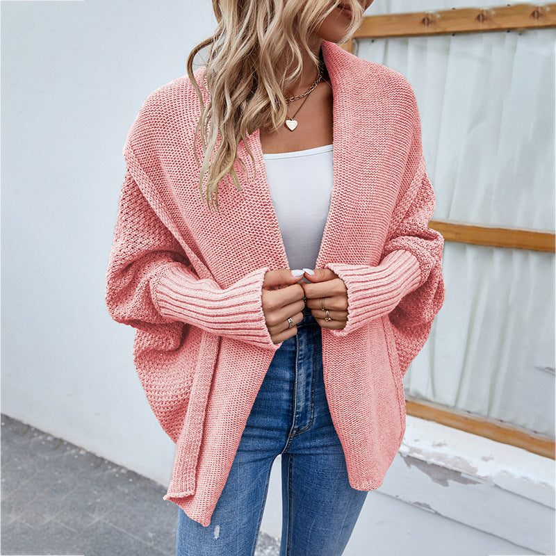 Pink knit cardigan with open front, long sleeves, textured waffle weave.