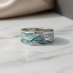 Polished silver ring featuring turquoise wave inlay and engraved side detailing