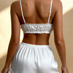 Back view of Angie satin pajama set: white ruched bandeau camisole and ruffle shorts