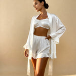 Angie satin pajama set in white: cropped camisole, ruffle shorts, and belted robe