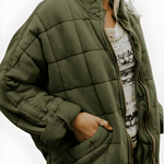 Olive green quilted puffer jacket with full zipper and side pockets, stand collar.