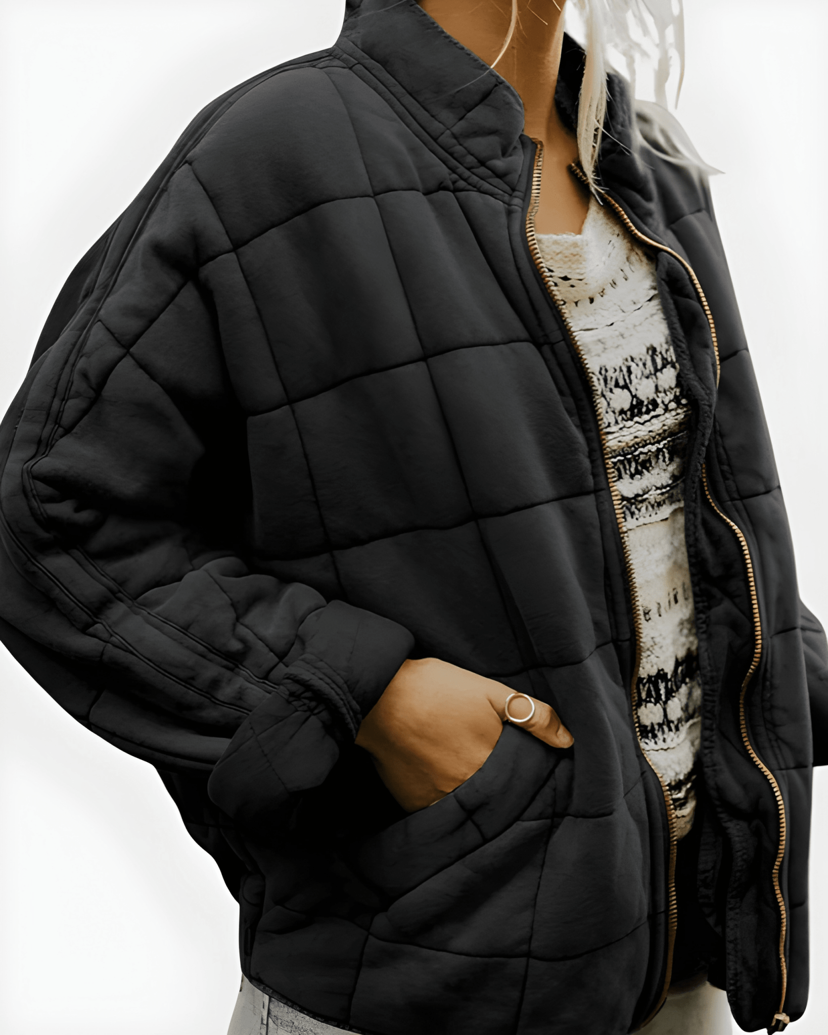 Black roomy quilted puffer jacket, full-zip front, side pockets.