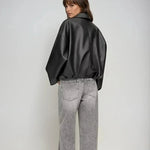 Black zip-front oversized jacket, back view, wide sleeves, belted waist