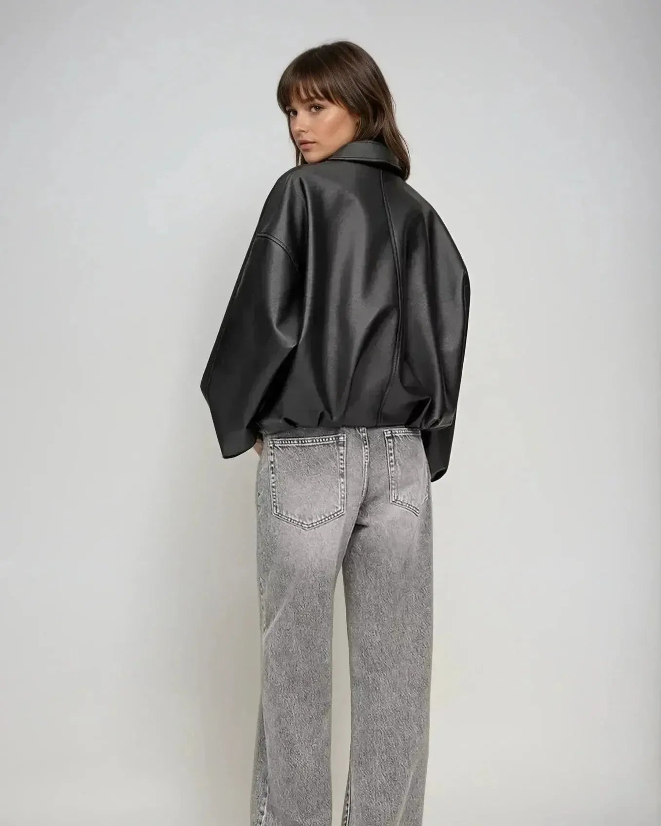 Black zip-front oversized jacket, back view, wide sleeves, belted waist