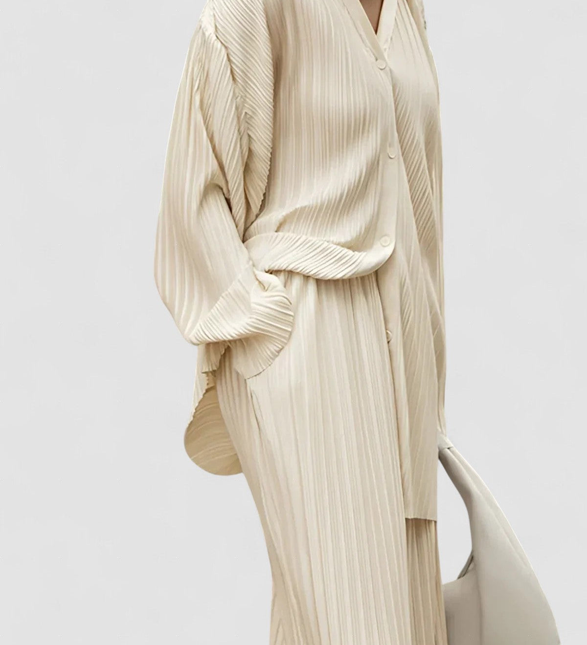 Beige pinstripe oversized two-piece set with wide-leg pants and pleated front pockets
