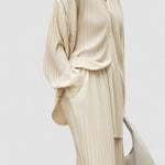 Beige pinstripe oversized two-piece set with wide-leg pants and pleated front pockets