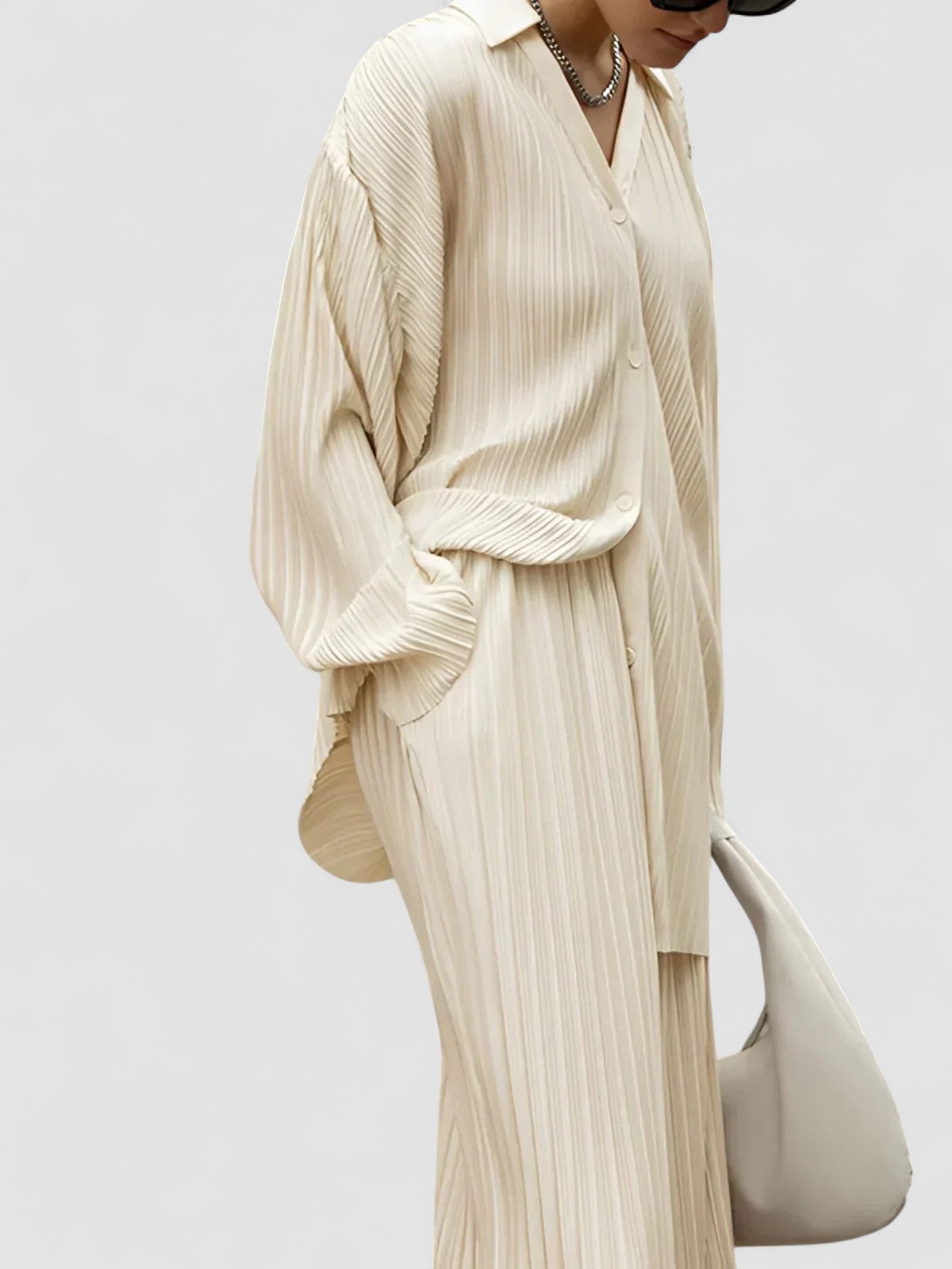 Beige pinstripe oversized two-piece set with wide-leg pants and pleated front pockets