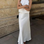 White satin sleeveless crop top and high-waist long maxi skirt