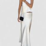 White satin sleeveless crop top with long matching maxi skirt, open back