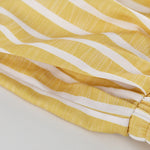 Yellow and white striped fabric panel, seam and stitched edge