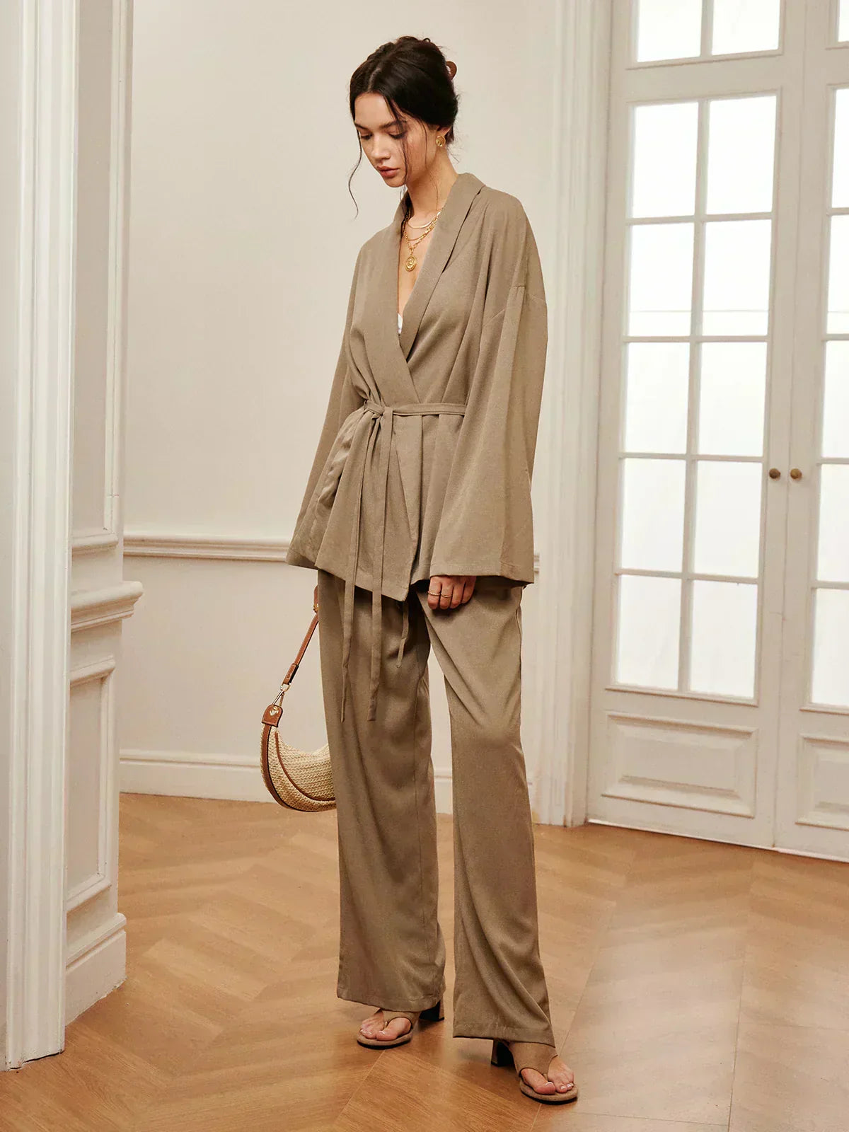 Women’s khaki wrap top and wide-leg pants with waist belt tie, side view