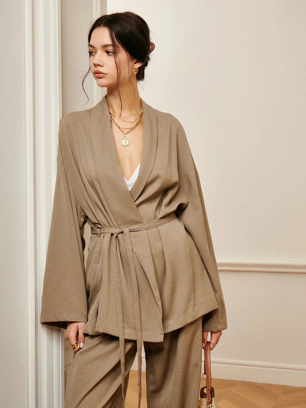 Women’s khaki wrap blouse and wide-leg trousers set with waist belt tie