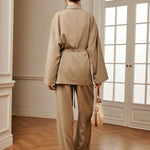 Women’s khaki wrap blouse and wide-leg pants set with waist belt tie, back view