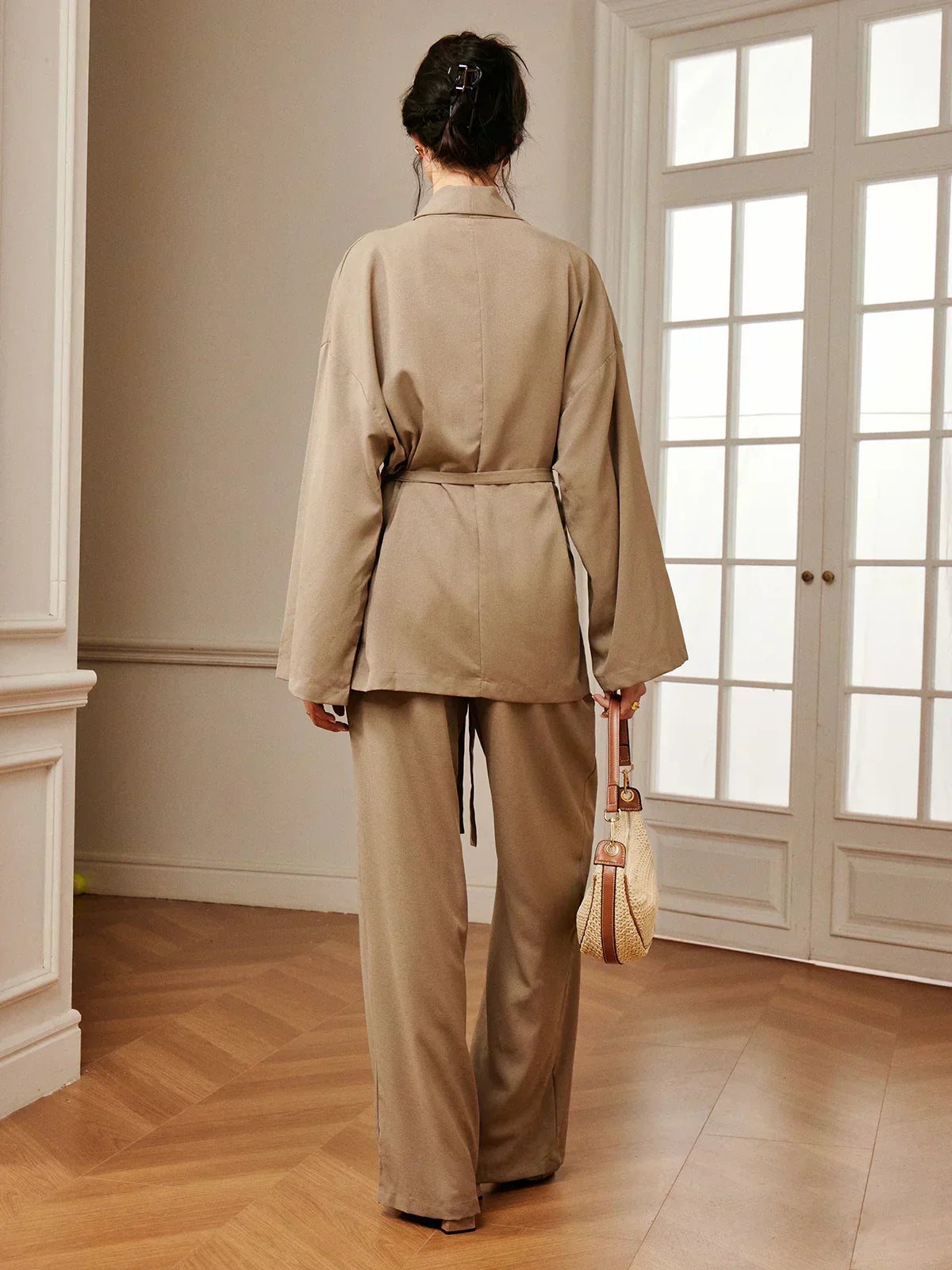 Women’s khaki wrap blouse and wide-leg pants set with waist belt tie, back view