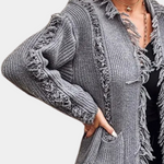 Gray ribbed knit cardigan with fringe trim and tassel detail along open front edges