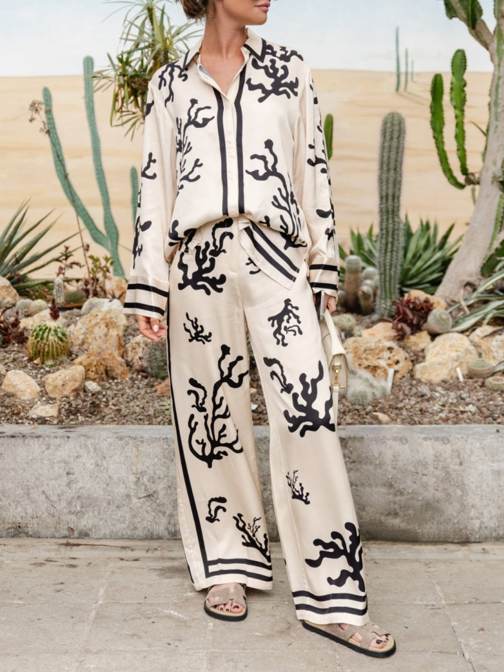 Silk pajama set with cream-and-black coral print, long-sleeve shirt and matching wide-leg pants