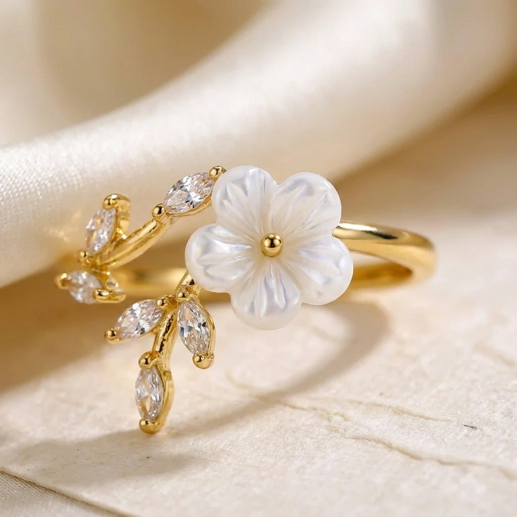 Gold-tone ring with large white flower and clear marquise crystals, side view