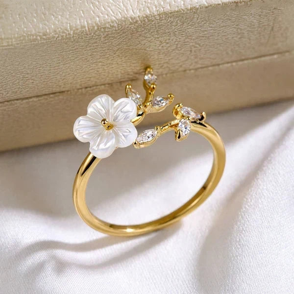Gold-tone ring with white flower and clear marquise crystals on branch setting
