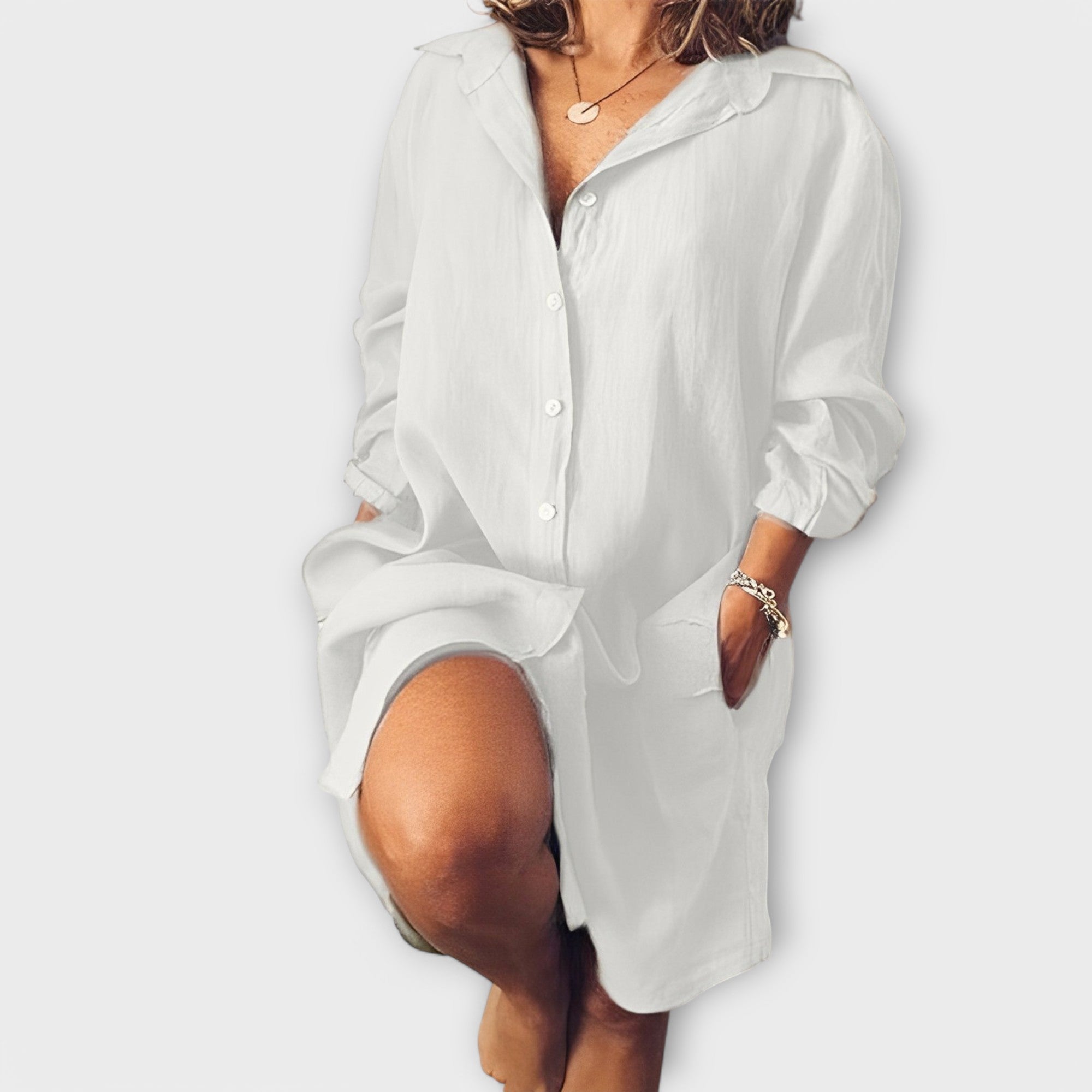 Loose linen shirt-dress, white, button-front, point collar, long sleeves, relaxed fit.