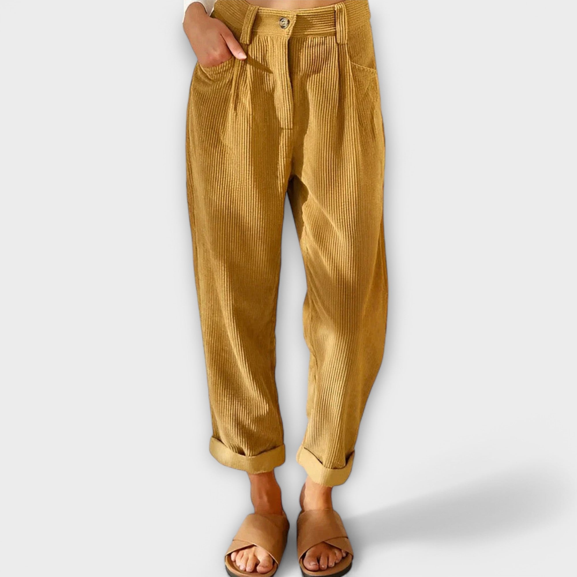 Cropped mustard yellow pants with pleats, button fly, and side pockets