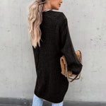 Long black knit cardigan, open front, textured knit with ribbed cuffs and hem.