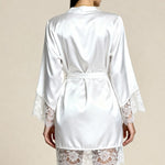 White satin kimono robe with lace-trim cuffs and back tie belt, worn over matching shorts