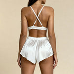 White satin backless pajama bra with crisscross straps and lace-trim shorts with tie waist