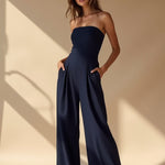 Navy strapless wide-leg jumpsuit with elasticated waist and flowing wide legs
