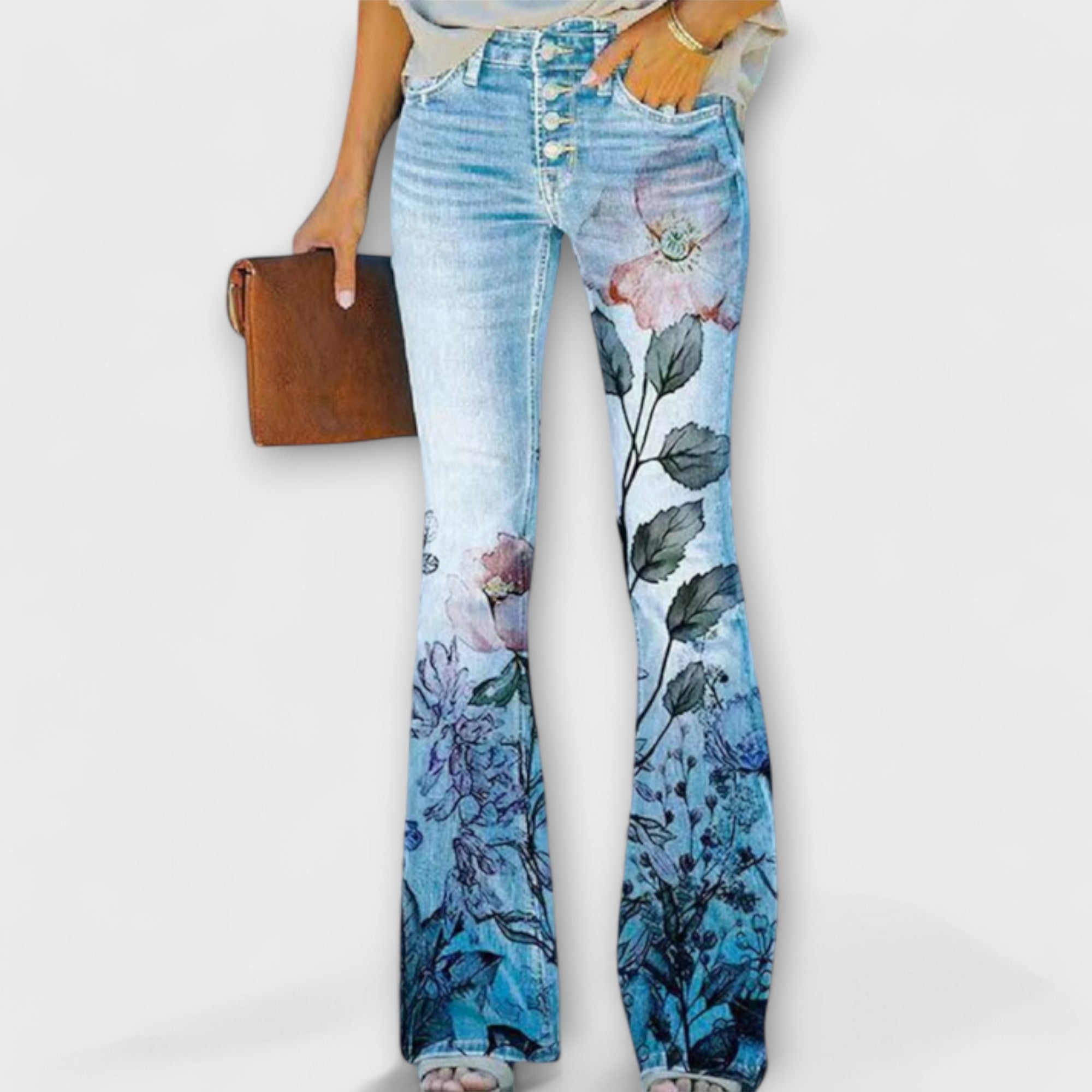 Floral print denim pants with large pink and blue flower prints on both legs