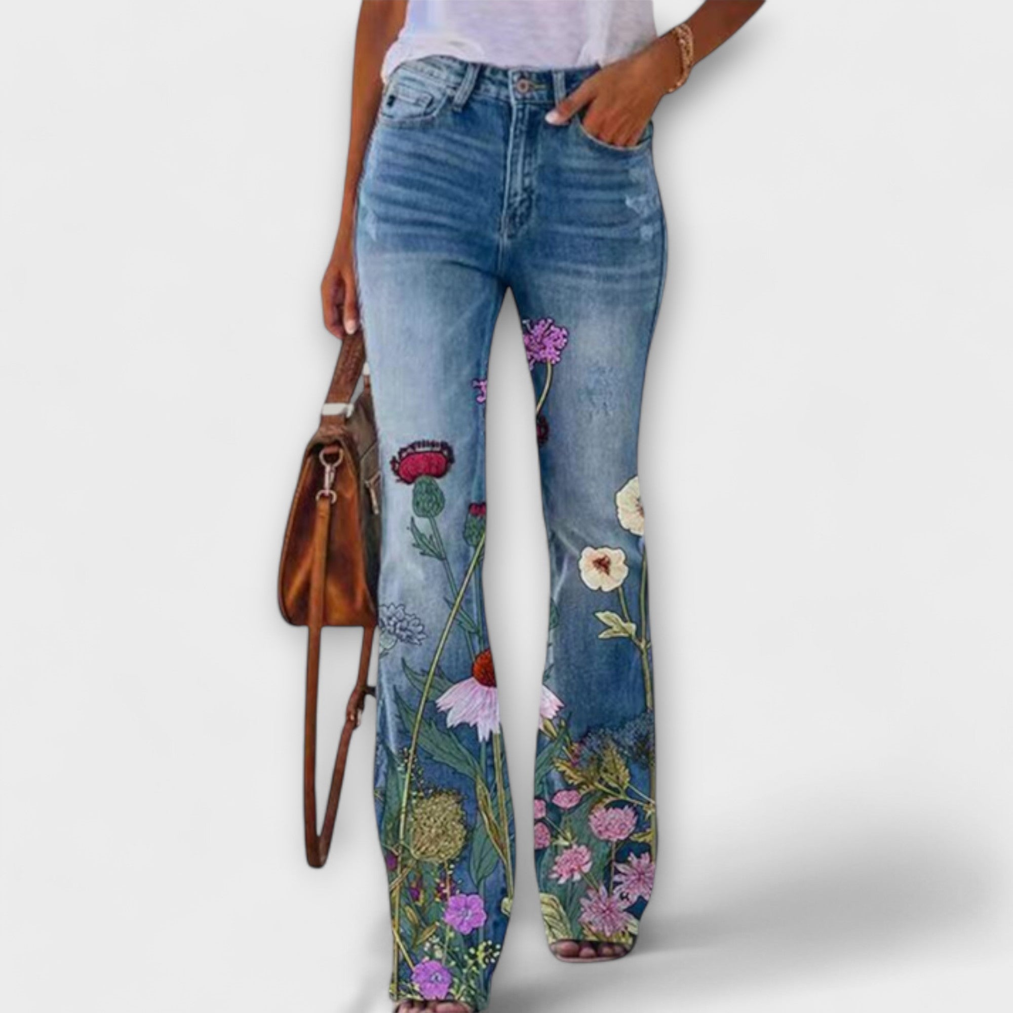 Floral print denim pants with mixed bouquet flowers and leaves on the lower legs