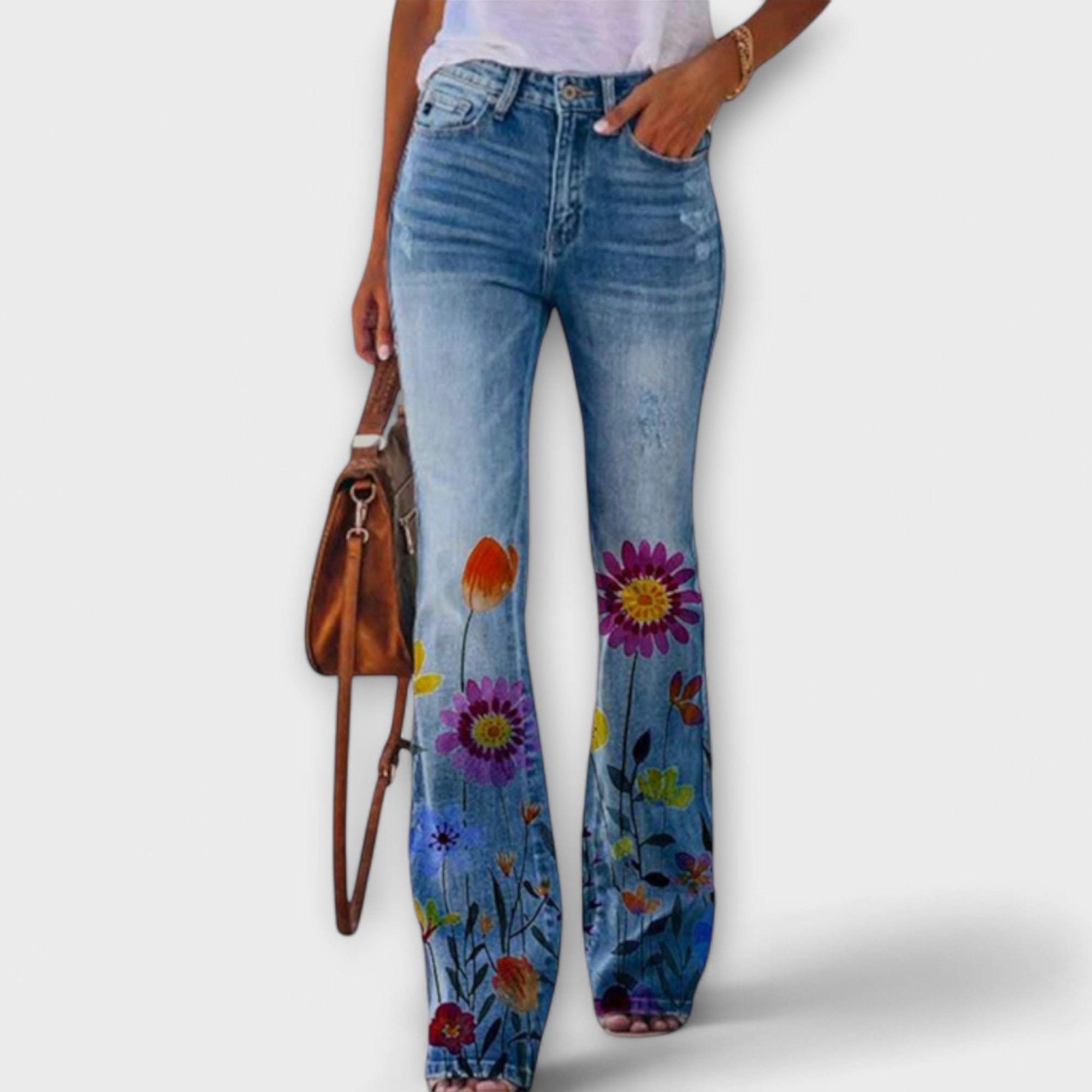 Floral print denim pants with purple and orange flowers at the lower legs