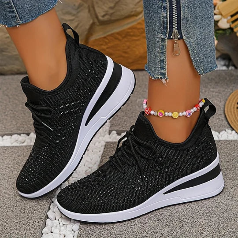 Black knit lace-up platform sneakers with breathable texture and thick white-rim sole