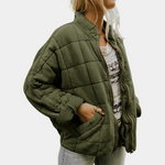 Dark green quilted puffer jacket with zip front, stand collar, and side pockets