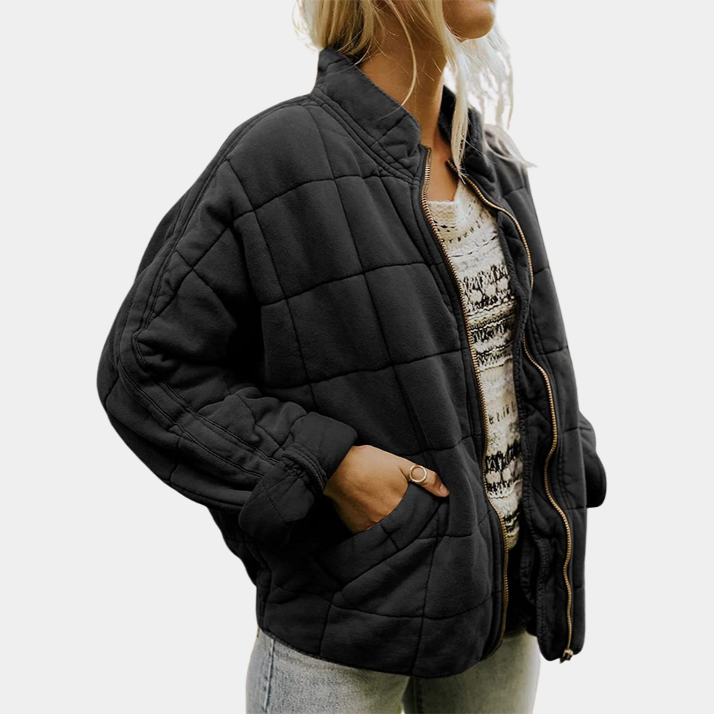 Black quilted puffer jacket with zip front, stand collar, and side pockets