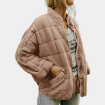 Light brown quilted puffer jacket with zip front and padded long sleeves