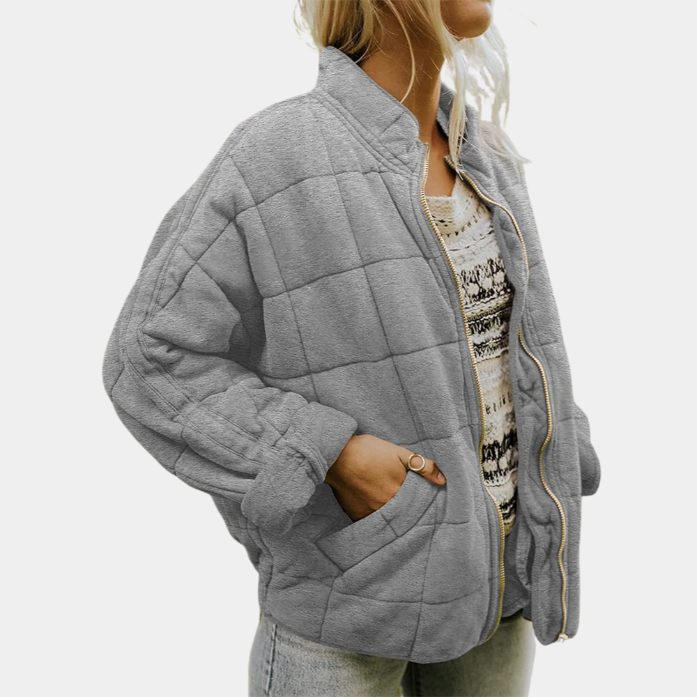 Gray quilted puffer jacket with zip front, stand collar, and padded long sleeves