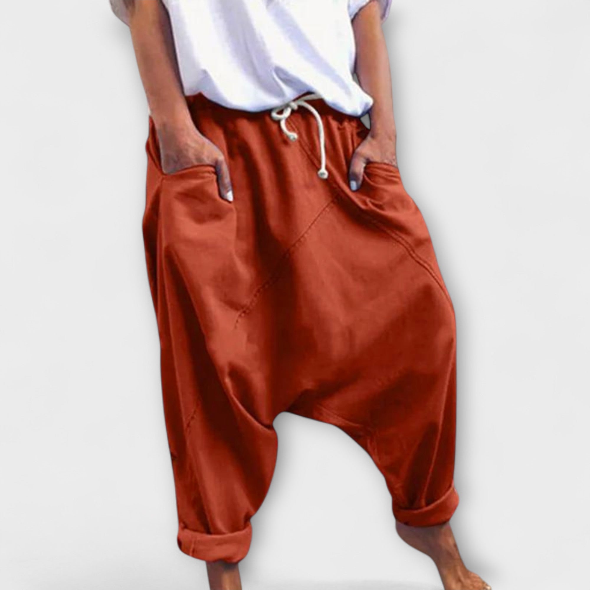 Wide-leg harem pants with drawstring waist, brick-orange, side pockets.